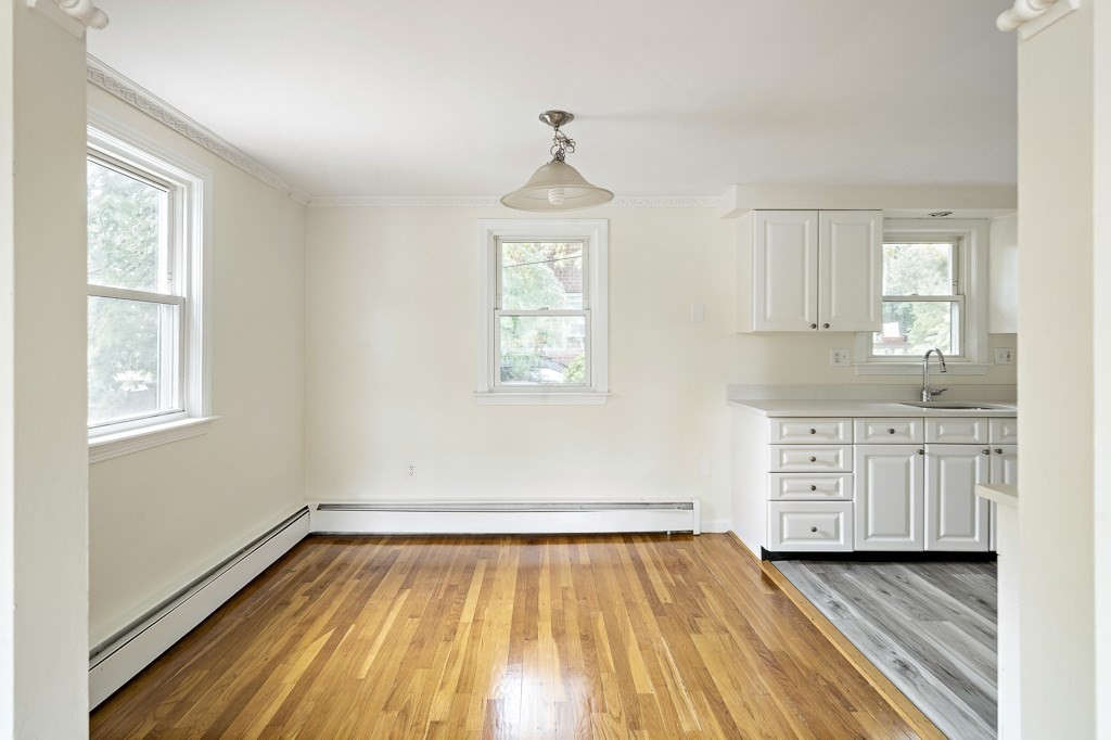 43 George Road, Unit 43 Winchester, MA 01890 - Photo 11 of 19 a view of a kitchen with wooden floor electronic appliances and windows