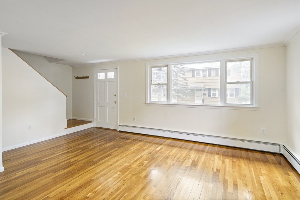 43 George Road, Unit 43 Winchester, MA 01890 - Photo 12 of 19 a view of an empty room with wooden floor and a window