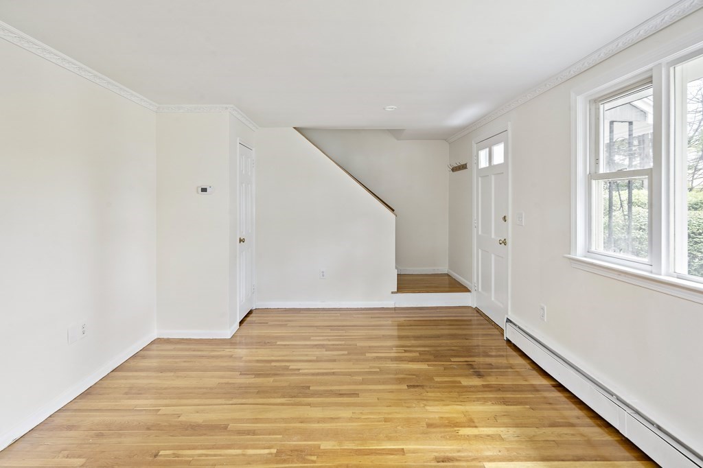 43 George Road, Unit 43 Winchester, MA 01890 - Photo 14 of 19 a view of an empty room with wooden floor and a window