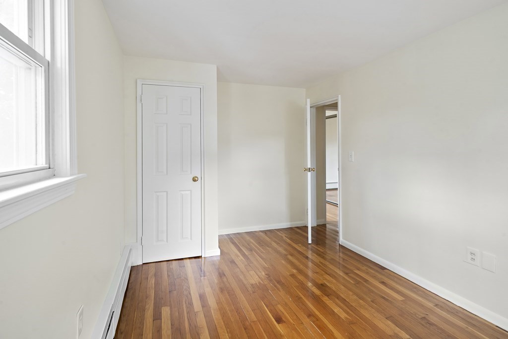 43 George Road, Unit 43 Winchester, MA 01890 - Photo 17 of 19 an empty room with wooden floor and windows