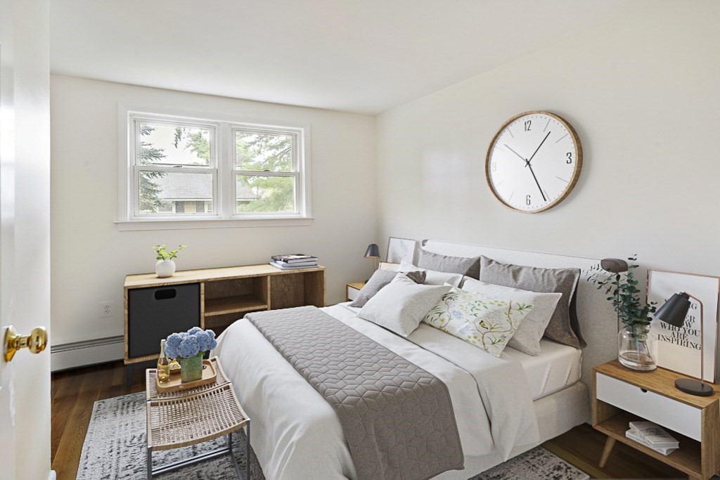 43 George Road, Unit 43 Winchester, MA 01890 - Photo 3 of 19 a bedroom with bed and a chandelier