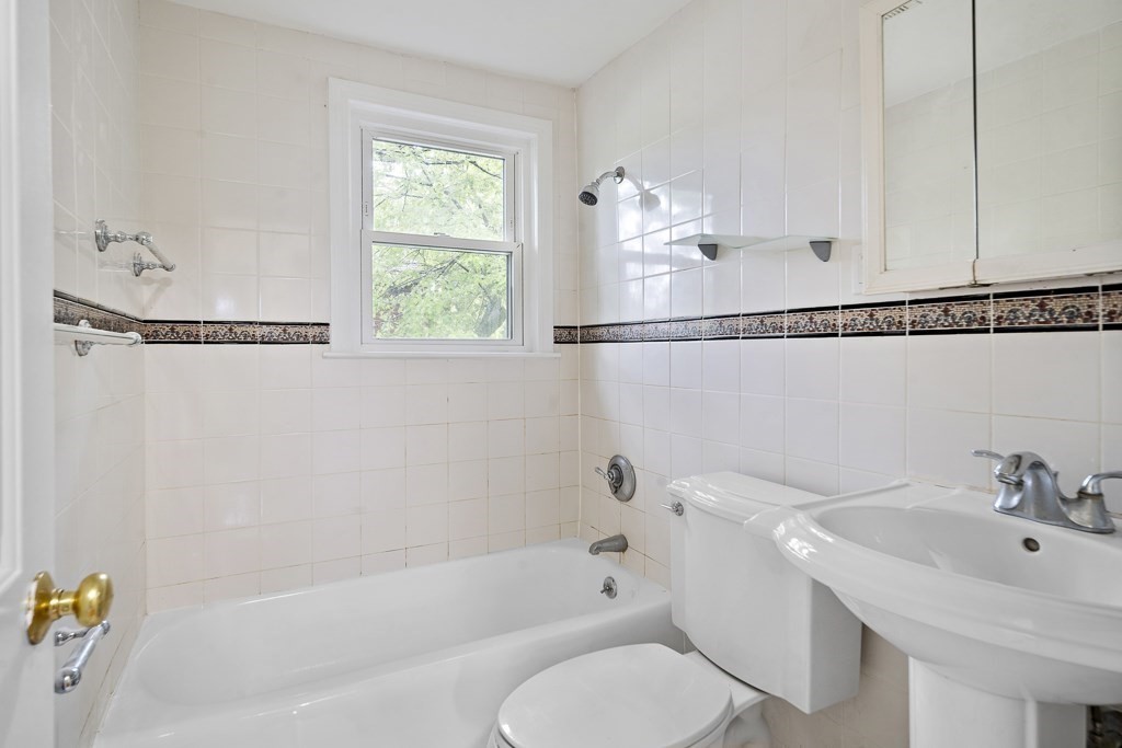 43 George Road, Unit 43 Winchester, MA 01890 - Photo 5 of 19 a bathroom with a sink a toilet and shower
