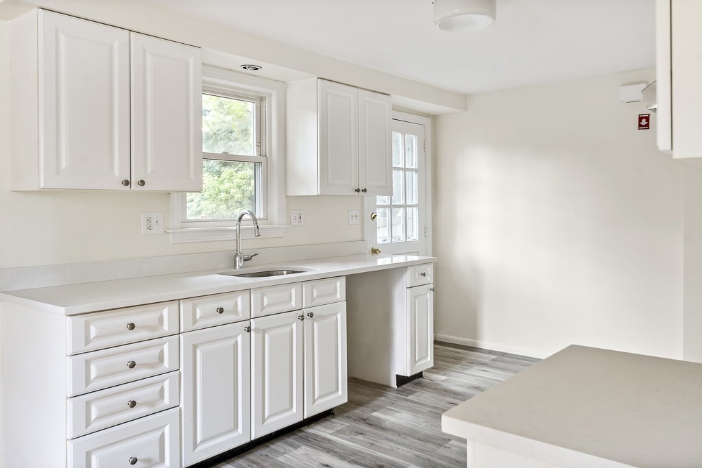 43 George Road, Unit 43 Winchester, MA 01890 - Photo 8 of 19 a kitchen with white cabinets and window