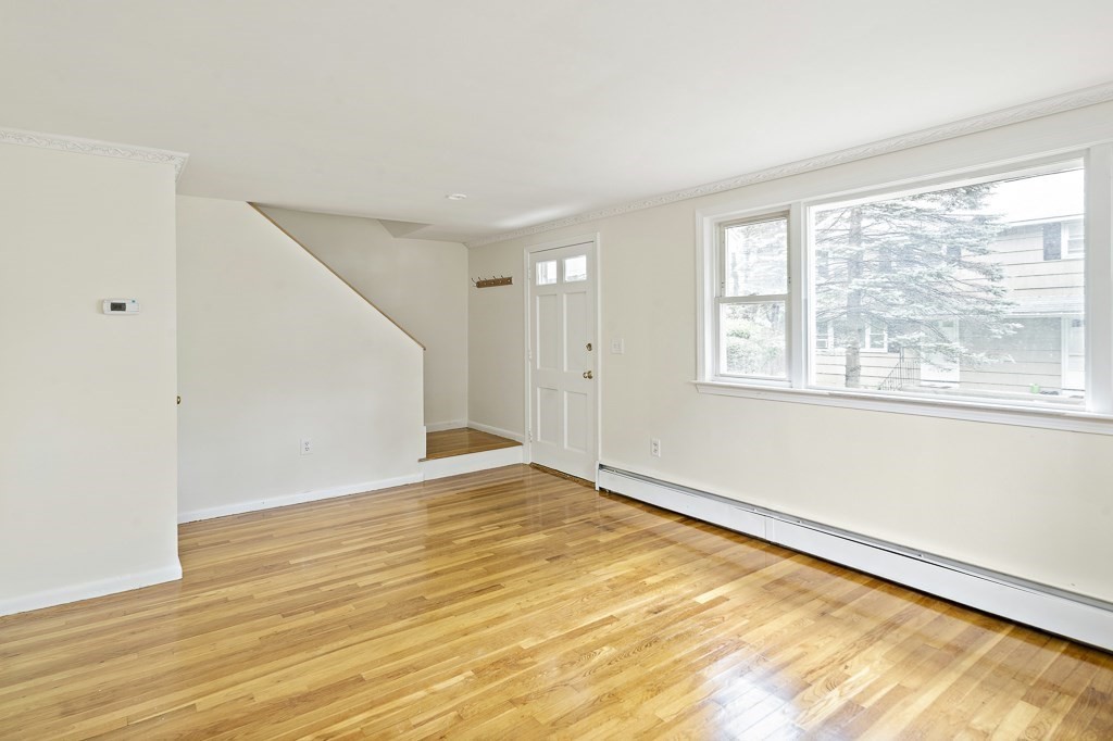 43 George Road, Unit 43 Winchester, MA 01890 - Photo 10 of 19 a view of an empty room with wooden floor and a window