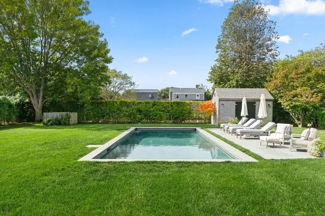 a view of yard with swimming pool and green space