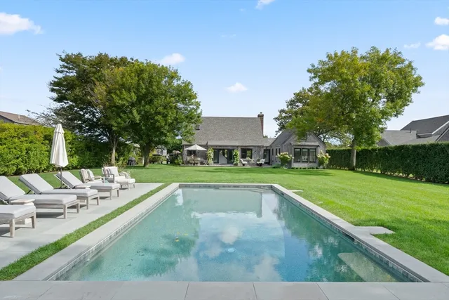 a view of a swimming pool and a yard