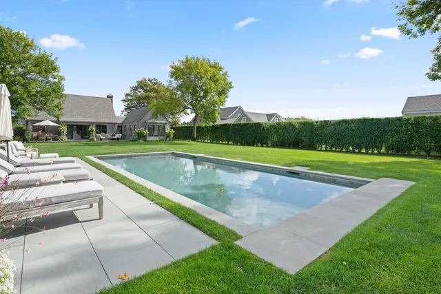 a view of a patio with couches table and chairs and potted plants