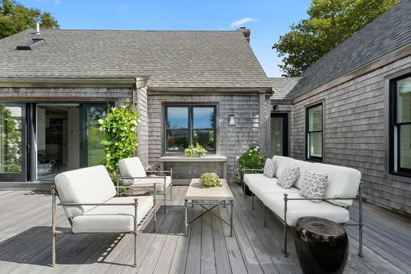 a view of a patio with table and chairs under an umbrella