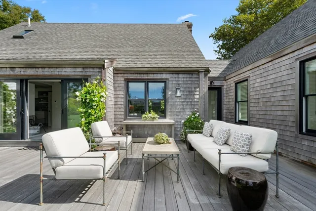 a view of a patio with table and chairs under an umbrella