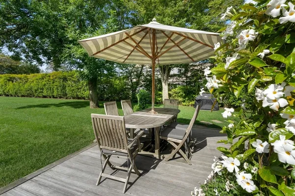 a outdoor space with patio the couches and a dining table with garden view
