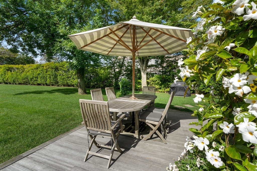 1 Doc Ryder Drive Nantucket, MA 02554 - Photo 15 of 42 a view of a patio with table and chairs under an umbrella