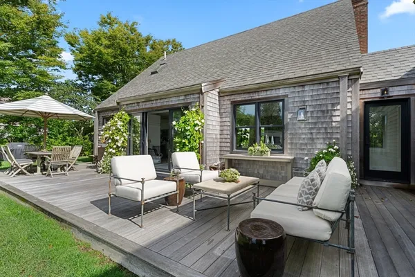 a backyard of a house with table and chairs