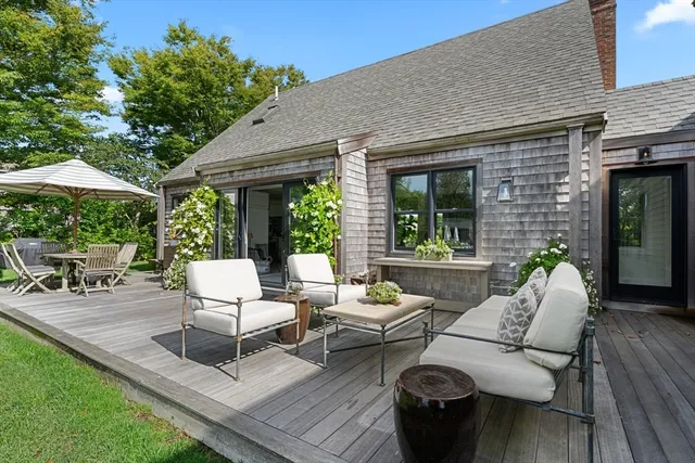 a backyard of a house with table and chairs