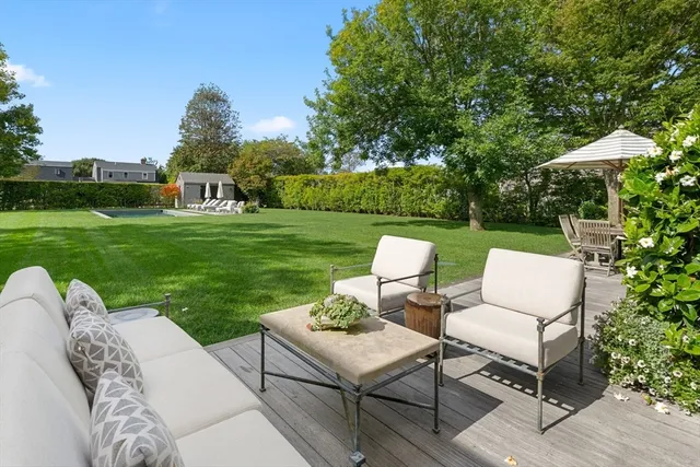 a living room with furniture a flat screen tv and a potted plant