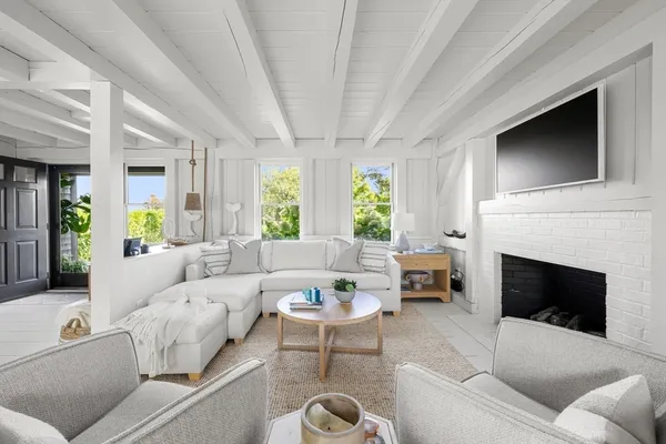 a living room with furniture fireplace and window