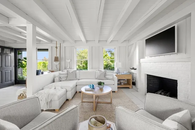 a living room with furniture fireplace and window