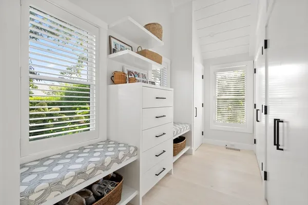 a spacious bedroom with a bed and glass door