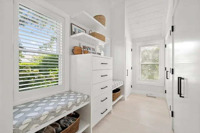 a spacious bedroom with a bed and glass door