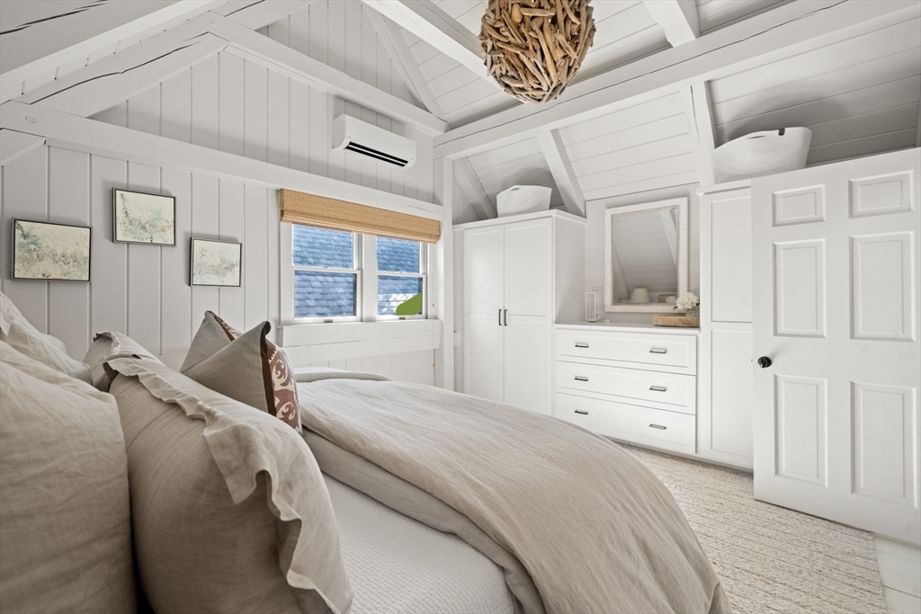 1 Doc Ryder Drive Nantucket, MA 02554 - Photo 22 of 42 a spacious bedroom with a bed and glass door