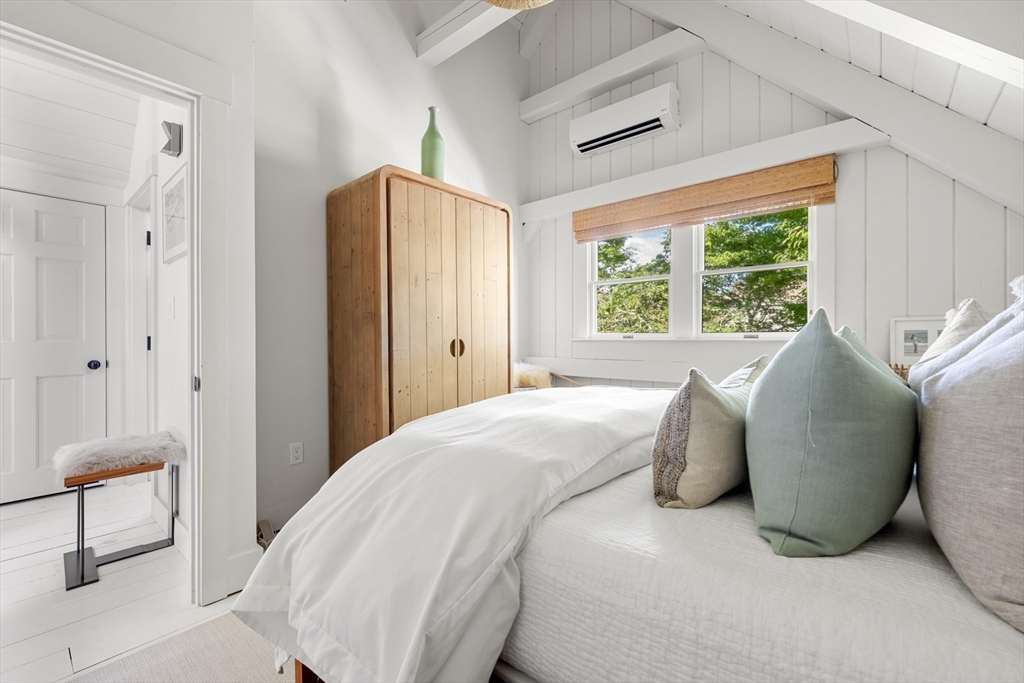 1 Doc Ryder Drive Nantucket, MA 02554 - Photo 26 of 42 a large bed sitting in a bedroom next to a window