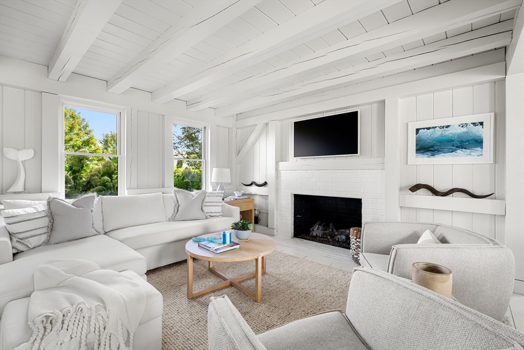 1 Doc Ryder Drive Nantucket, MA 02554 - Photo 3 of 42 a living room with furniture a flat screen tv and a fireplace