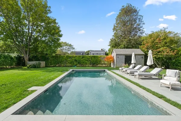 a view of a swimming pool and a yard