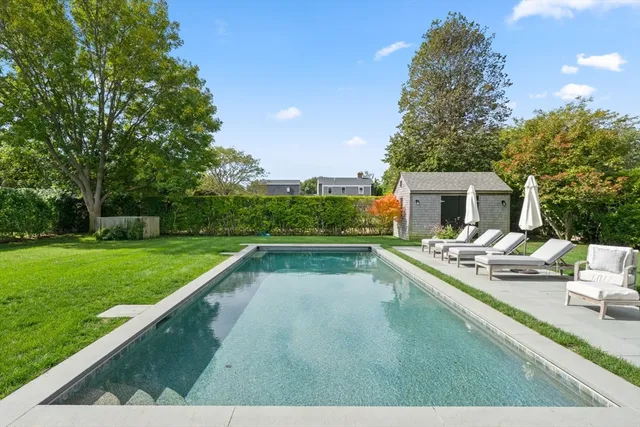 a view of a swimming pool and a yard
