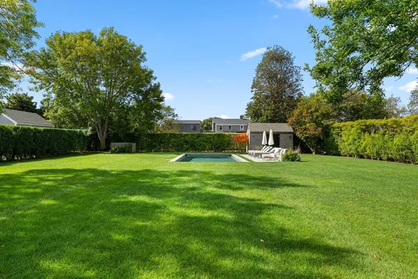 a view of a house with backyard sitting area and garden