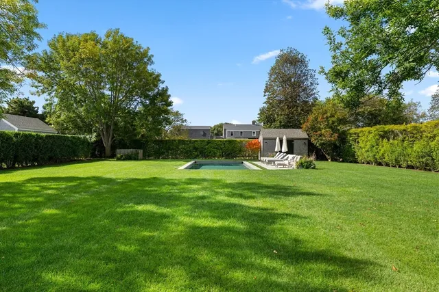 a view of a house with backyard sitting area and garden