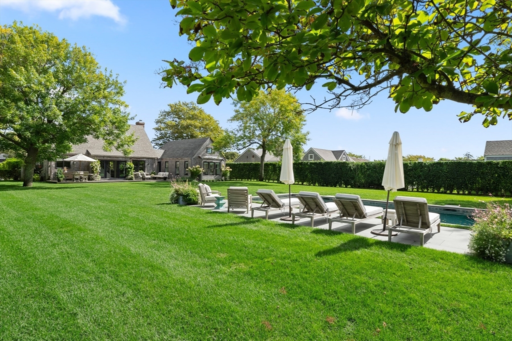 1 Doc Ryder Drive Nantucket, MA 02554 - Photo 37 of 42 a view of a house with backyard sitting area and garden
