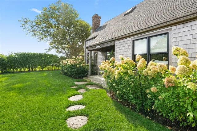 a front view of a house with a yard and porch
