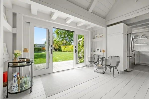 a view of a house with a yard and sitting area