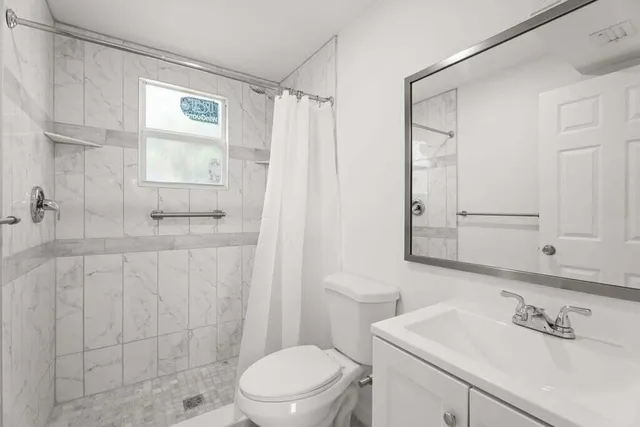 a bathroom with a sink toilet and shower