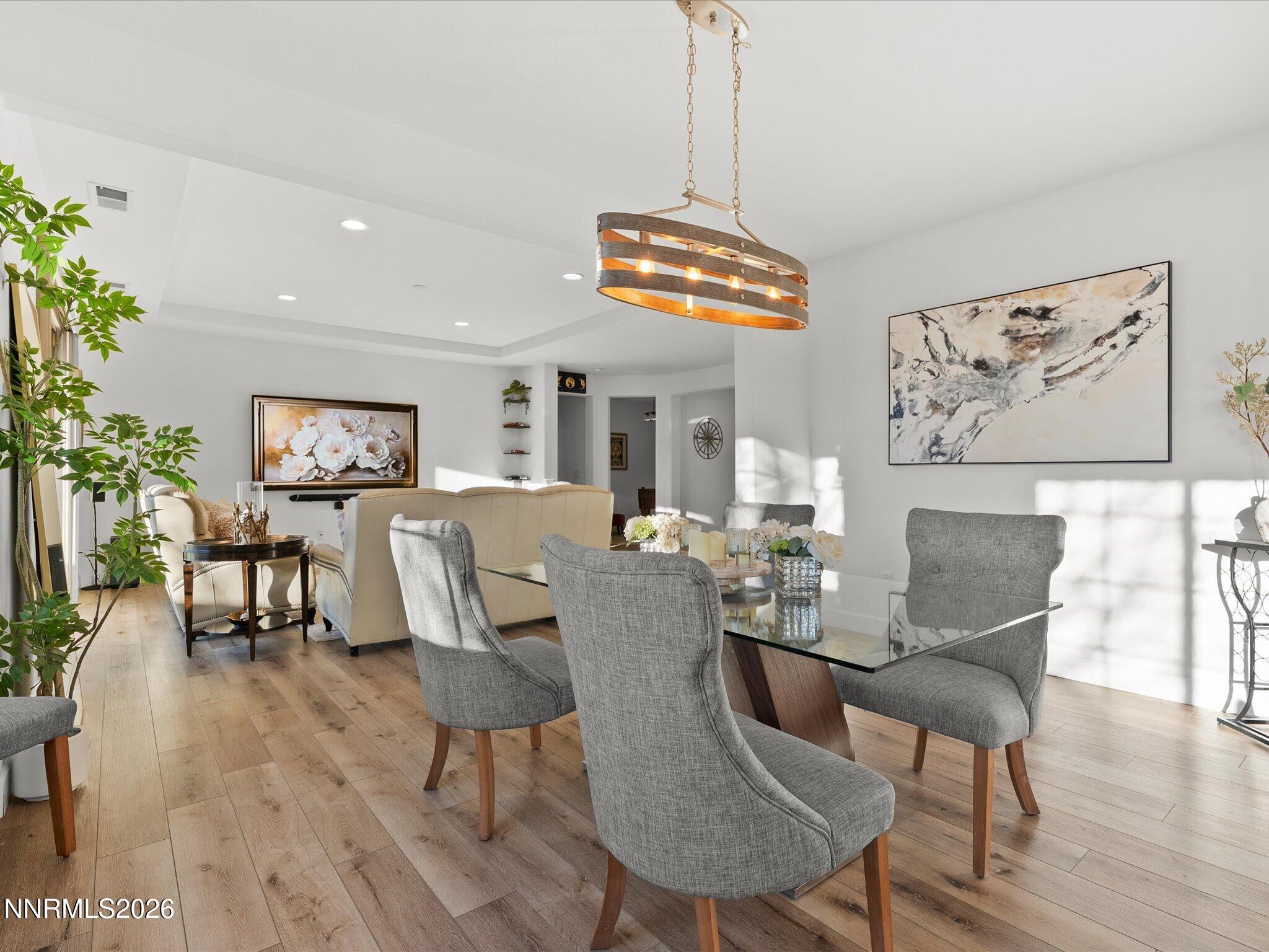 9803 Ash Meadow Drive Reno, NV 89521 - Photo 15 of 56 a view of a dining room with furniture window and wooden floor
