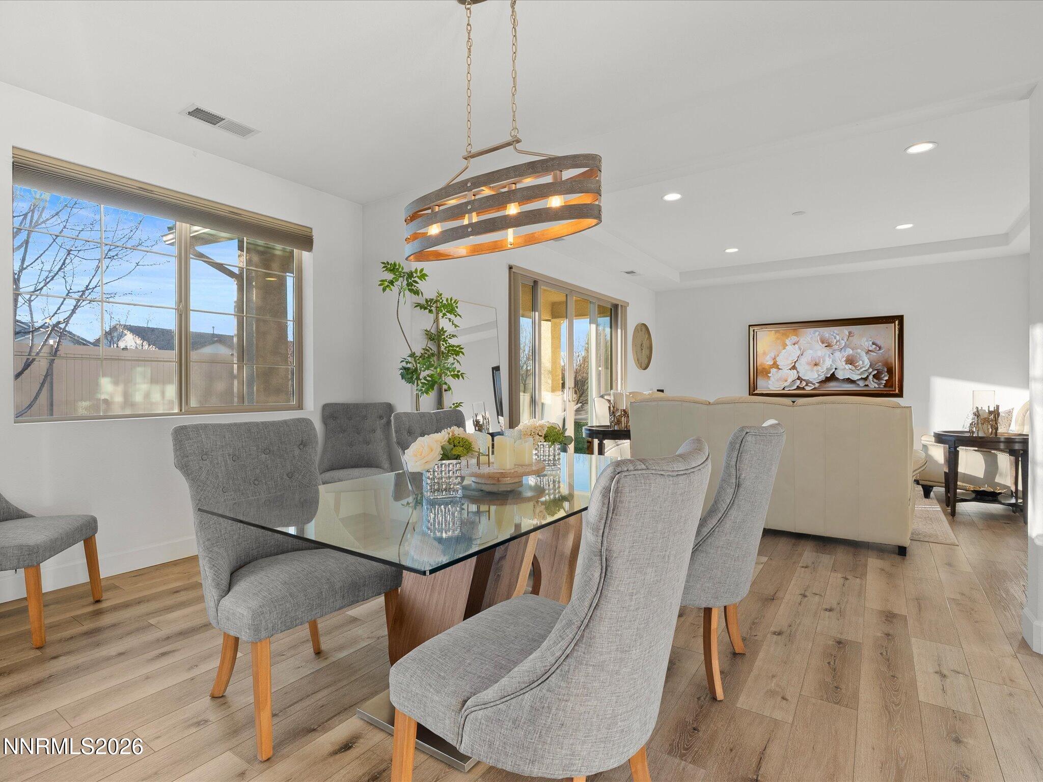 9803 Ash Meadow Drive Reno, NV 89521 - Photo 16 of 56 a view of a dining room with furniture window and wooden floor