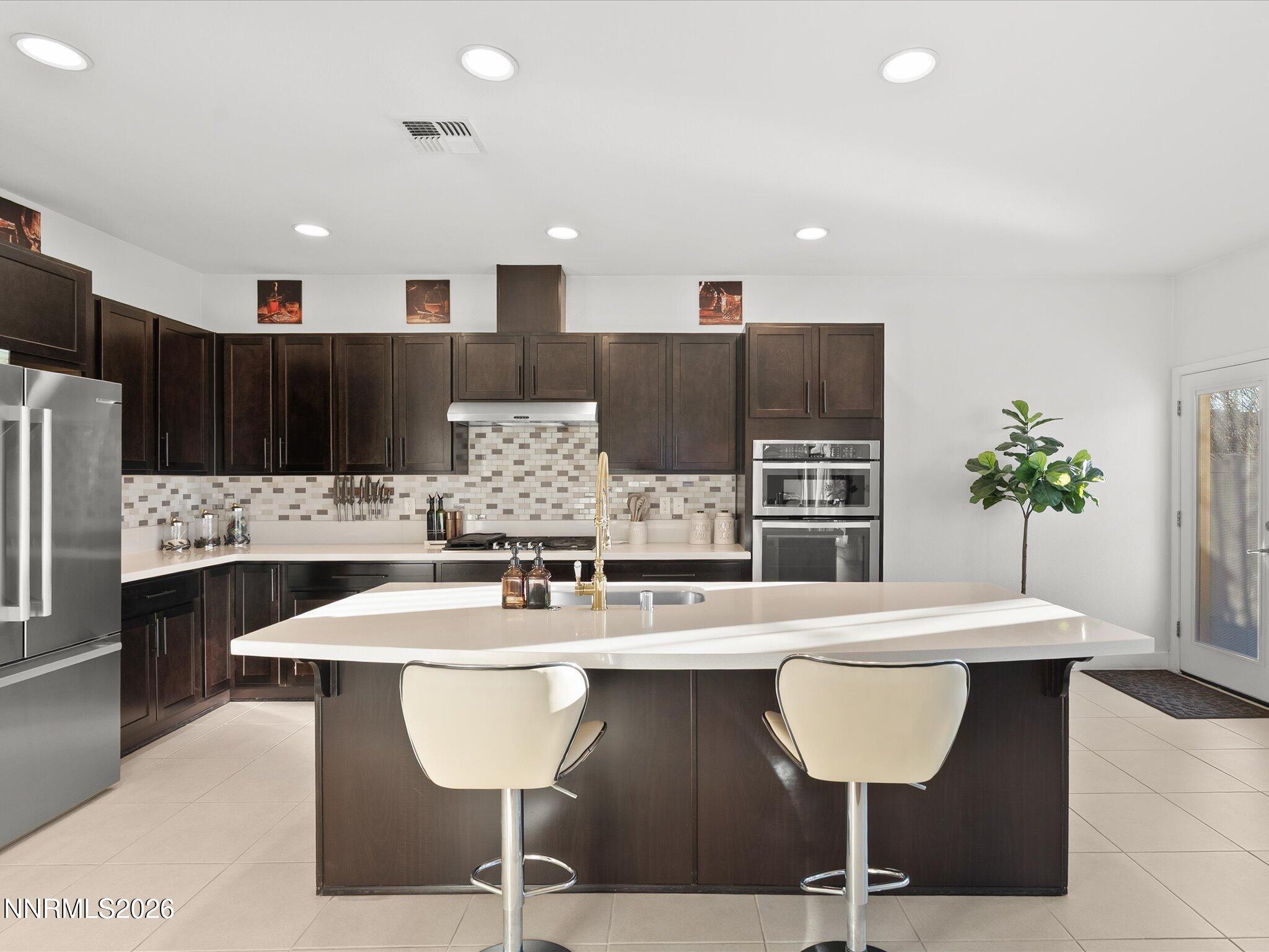 9803 Ash Meadow Drive Reno, NV 89521 - Photo 18 of 56 a kitchen with a table chairs and a kitchen