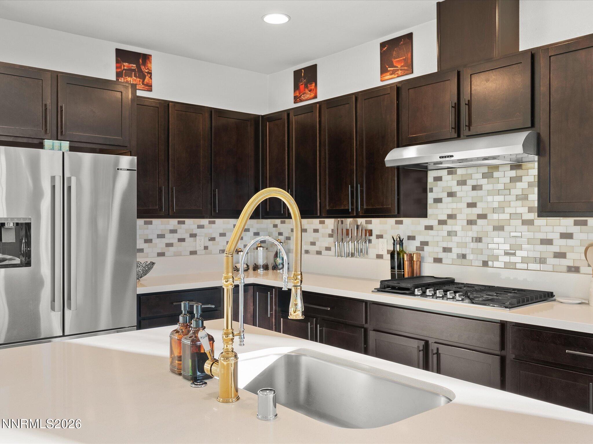 9803 Ash Meadow Drive Reno, NV 89521 - Photo 22 of 56 a kitchen with stainless steel appliances a sink and a refrigerator