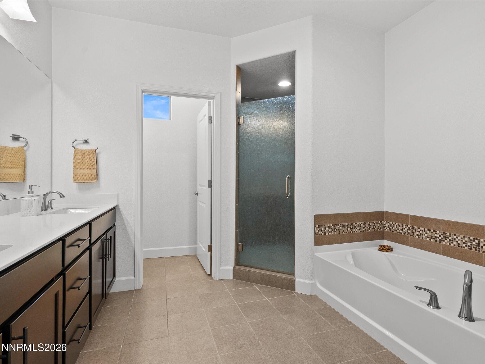 9803 Ash Meadow Drive Reno, NV 89521 - Photo 29 of 56 a bathroom with a bathtub and a sink