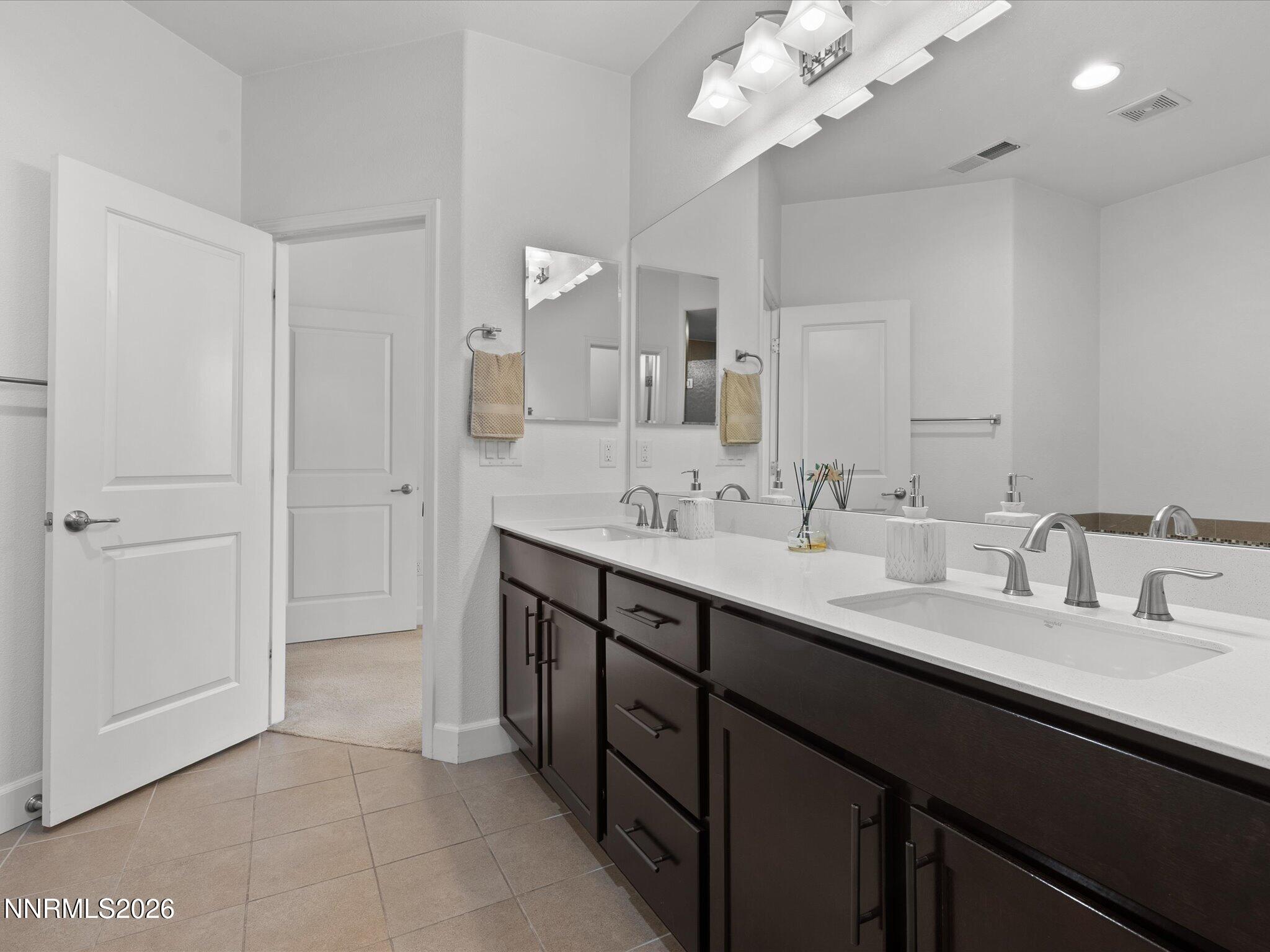 9803 Ash Meadow Drive Reno, NV 89521 - Photo 31 of 56 a bathroom with a sink vanity and a mirror