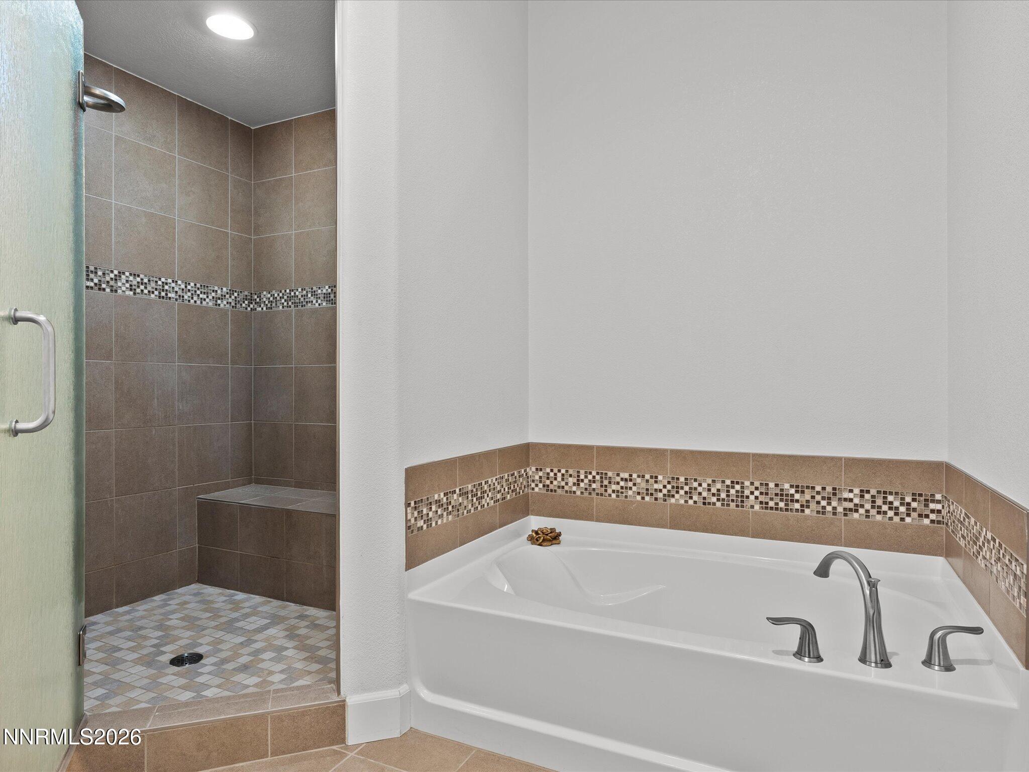 9803 Ash Meadow Drive Reno, NV 89521 - Photo 32 of 56 a bathroom with a bathtub and shower