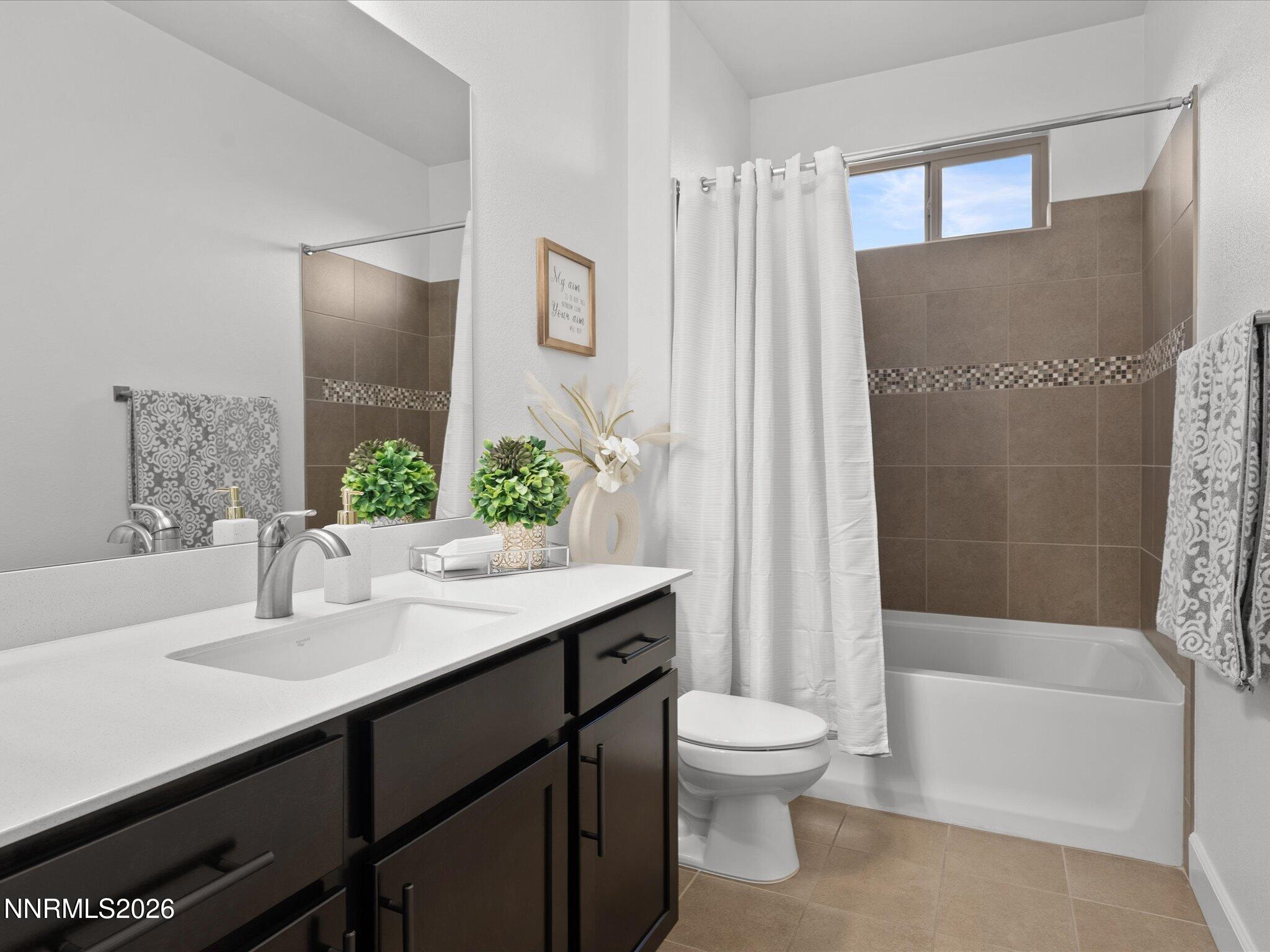 9803 Ash Meadow Drive Reno, NV 89521 - Photo 34 of 56 a bathroom with a sink a toilet and shower