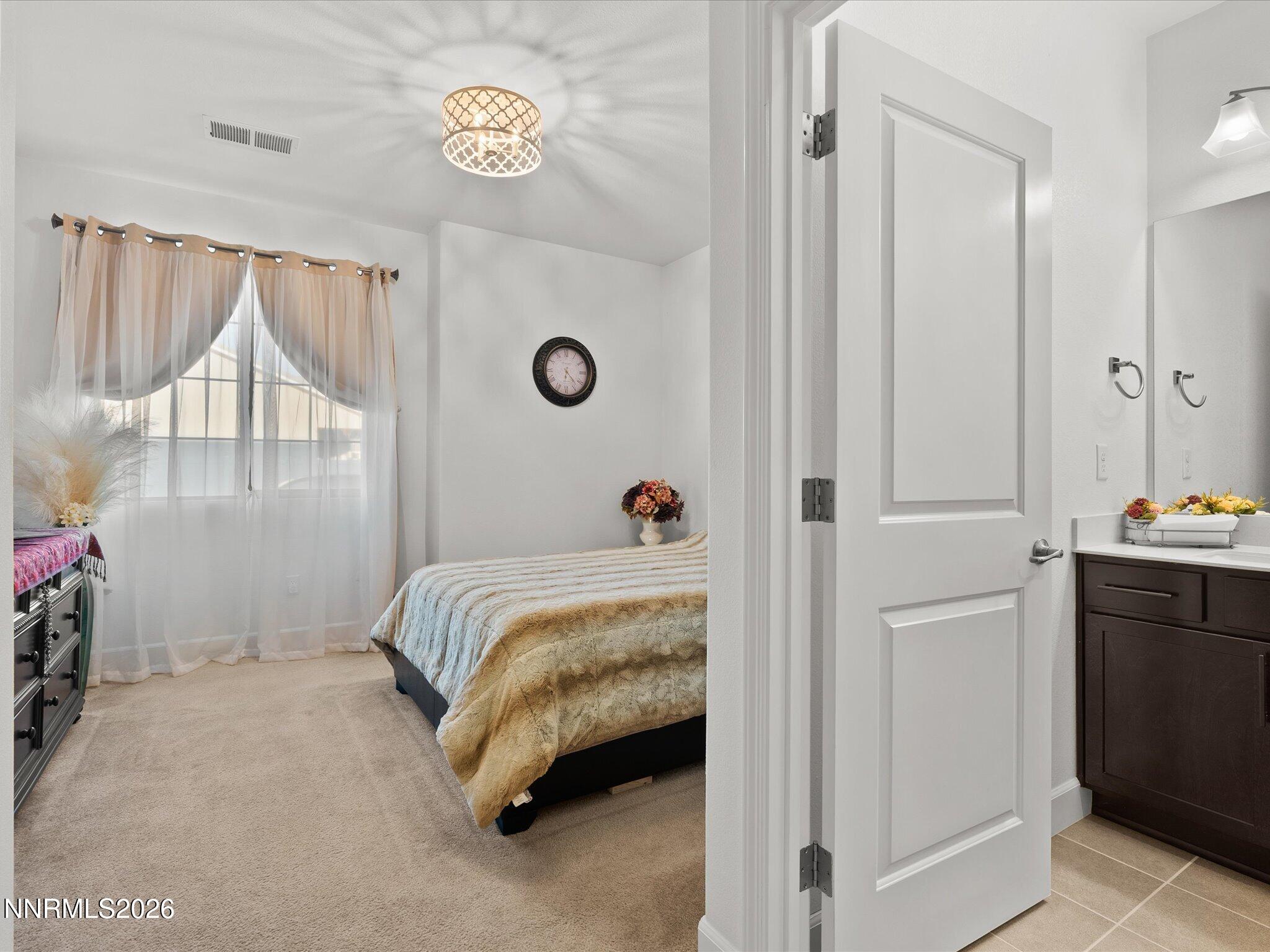 9803 Ash Meadow Drive Reno, NV 89521 - Photo 36 of 56 a bedroom with a bed and a window