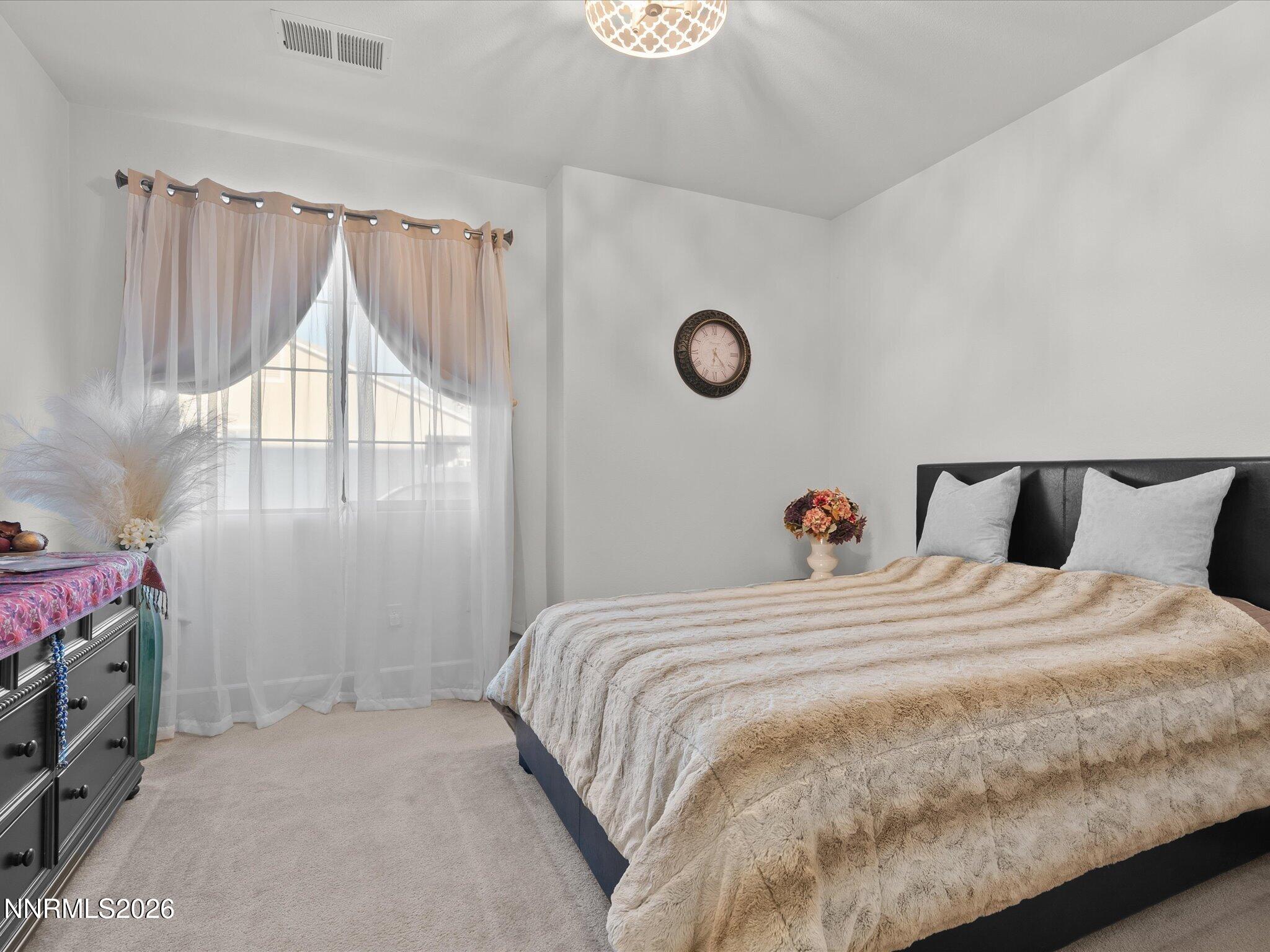 9803 Ash Meadow Drive Reno, NV 89521 - Photo 37 of 56 a bedroom with a bed and a window