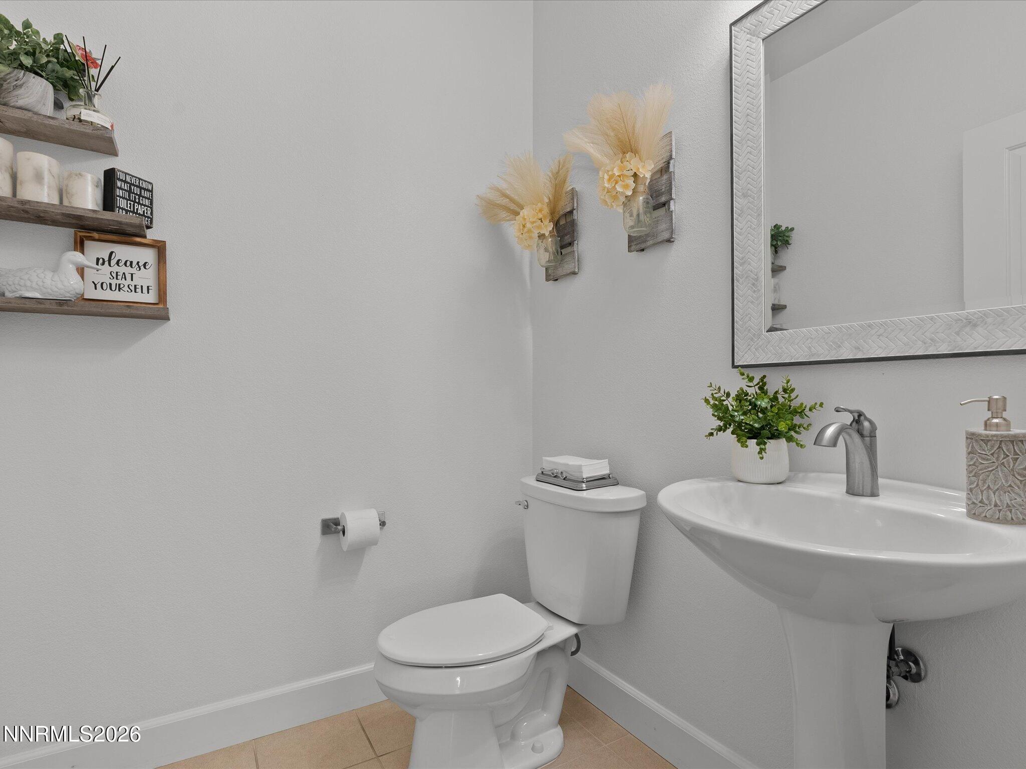 9803 Ash Meadow Drive Reno, NV 89521 - Photo 39 of 56 a white toilet sitting next to a white sink