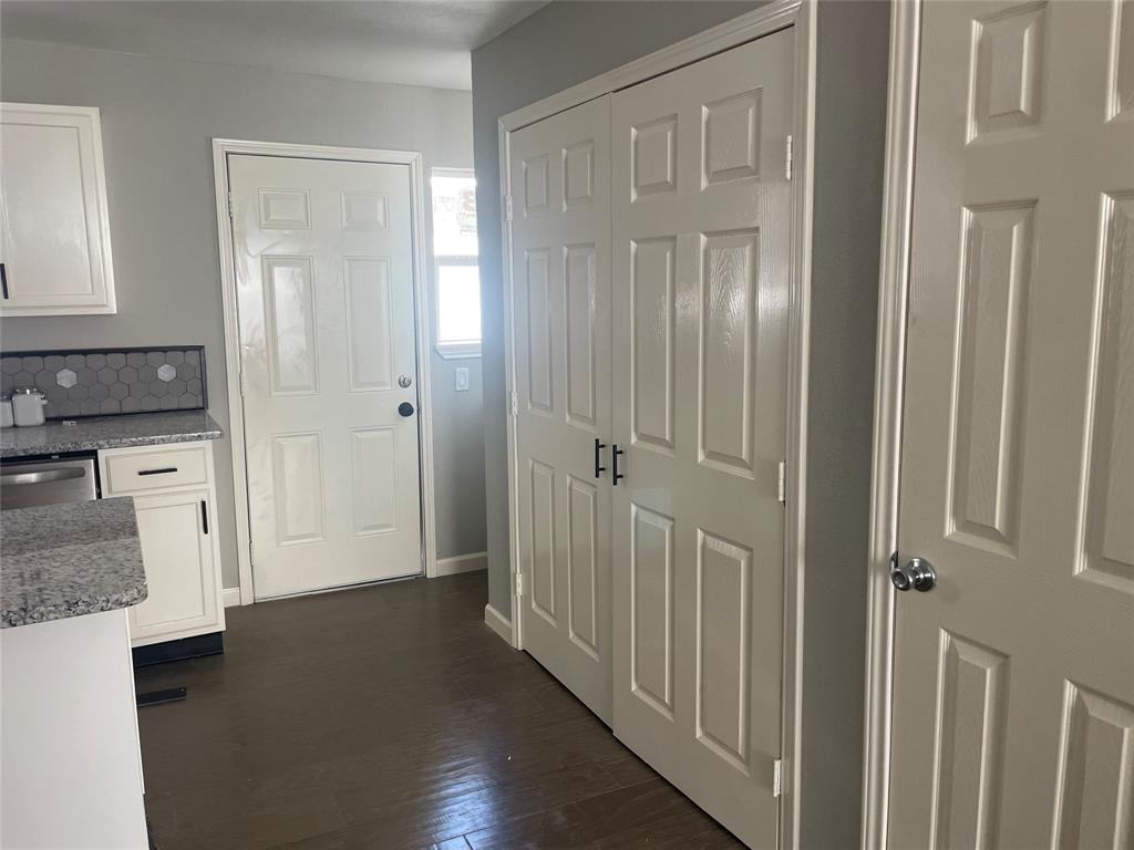 203 Broad Street McKinney, TX 75069 - Photo 11 of 19 a view of a hallway with wooden floor and staircase