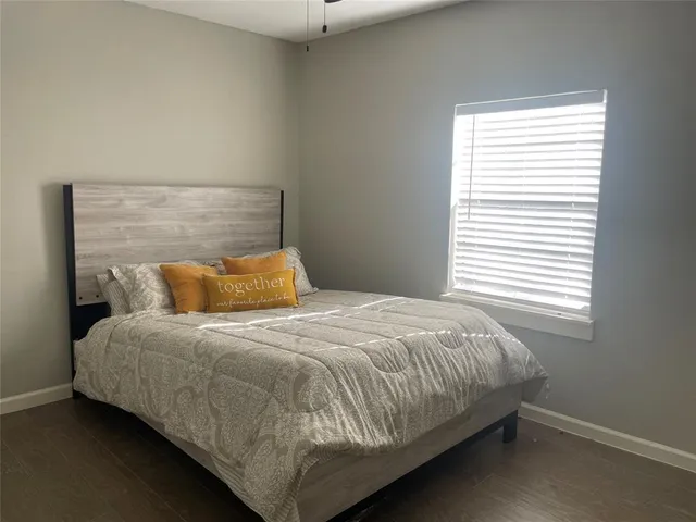 a bedroom with a bed and window