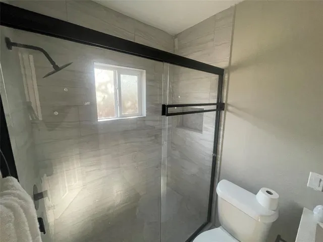 a bathroom with a glass shower door