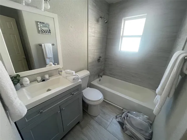 a bathroom with a sink toilet tub and shower