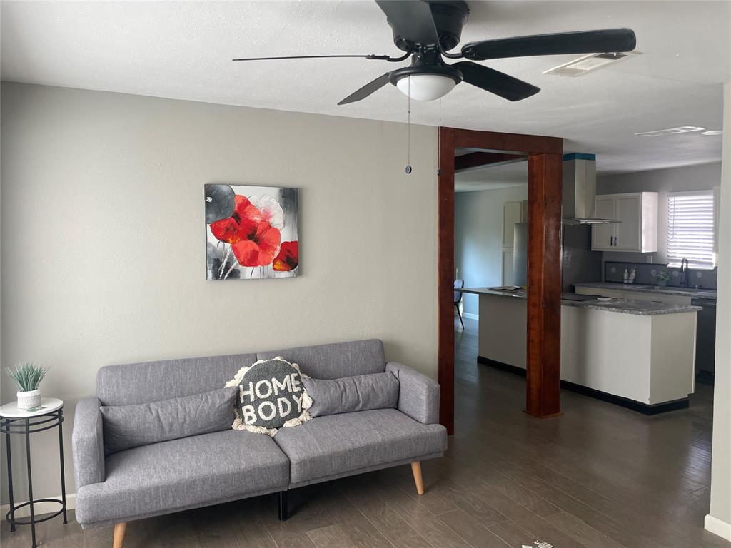 203 Broad Street McKinney, TX 75069 - Photo 7 of 19 a living room with furniture and a ceiling fan