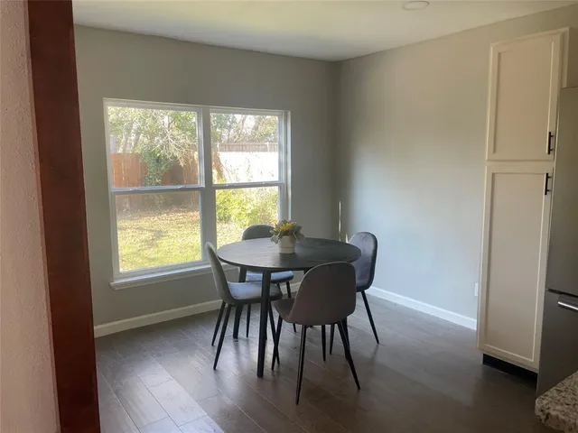 a view of a dining room with furniture and window